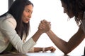 Young asian and caucasian businesswomen armwrestling struggle for leadership