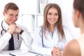 Two confident friendly doctors sitting at the table and listen to the patient`s history . Medical and health care