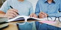 two confident students doing homework together while sitting at the home place Royalty Free Stock Photo