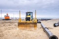 Two construction machines excavators and wheel loaders with sewer pipe