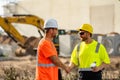 Two construction site workers in helmet work outdoors. Builders workers working on construction site. The job of a Royalty Free Stock Photo