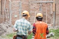 Two construction worker standing in front of the building site Royalty Free Stock Photo