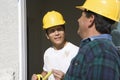 Two Construction Workers Checking Window Royalty Free Stock Photo