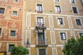 Two construction workers hanging on ropes working on a veranda in plaÃÂ§a del pi in Barcelona Spain