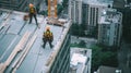 Two Construction Workers On A High-Rise Building Roof Royalty Free Stock Photo