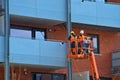 Construction Workers In Hydrolic Lift