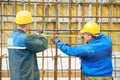 Two construction workers making reinforcement