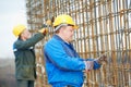 Two construction workers making reinforcement