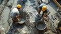 Two Construction Workers Mixing Cement in Buckets Royalty Free Stock Photo