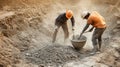 Two Construction Workers Mixing Concrete with Shovels Royalty Free Stock Photo