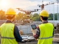 two construction workers are operating a drone on a construction site Royalty Free Stock Photo