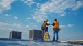 Two Construction Workers on a Roof with HVAC Units Royalty Free Stock Photo