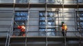 Two Construction Workers on Scaffolding During Building Renovation Royalty Free Stock Photo