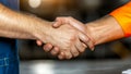 Two construction workers shake hands, signifying partnership and collaboration on a job site Royalty Free Stock Photo