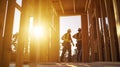 Two Construction Workers Standing in a Frame of a New Home Royalty Free Stock Photo