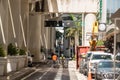 Two construction workers walking down the middle of a street