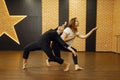 Two contemporary dance performers poses in studio