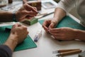 two contemporary working together in jewelry workshop. Master and apprentice. Young male assistant and female jeweler