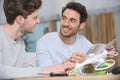 two contented men assembling drone Royalty Free Stock Photo
