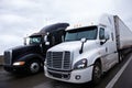 Two contrast modern semi truck different models black and white Royalty Free Stock Photo