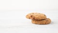 Two cookies with chocolate drops on white wooden table. Chocolate chip cookie. Morning portion of cookies. Text space