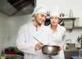 Two cooks at restaurant kitchen Royalty Free Stock Photo