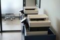 Two copiers stand in the copy room of coworking space