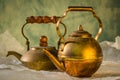 Two copper teapot on paper Royalty Free Stock Photo