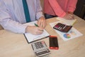 Two Corporate businessman working at office desk, he is using a calculator Royalty Free Stock Photo