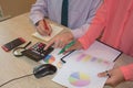 Two Corporate businessman working at office desk, he is using a calculator Royalty Free Stock Photo