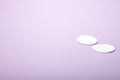 Two cosmetic cotton pads on a delicate pink background, spa, close-up Royalty Free Stock Photo