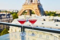 Two Cosmopolitan cocktails in traditional martini glasses with view to the Eiffel tower, Paris, France