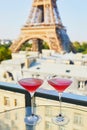 Two Cosmopolitan cocktails in traditional martini glasses with view to the Eiffel tower, Paris, France