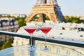 Two Cosmopolitan cocktails in traditional martini glasses with view to the Eiffel tower, Paris, France