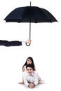 Two couple lying in studio under umbrella Royalty Free Stock Photo