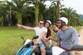 Two Couple Riding Motorbike, Young Man And Woman Using Cell Smart Phone Travel On Bike On Tropical Forest Road Royalty Free Stock Photo