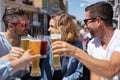 Two couples chinking glasses in outside bar Royalty Free Stock Photo