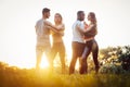 Two couples dancing kizomba during sunset in a park