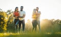 Two couples dancing kizomba during sunset in a park