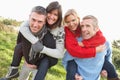 Two Couples Having Piggyback Ride In Autumn Royalty Free Stock Photo