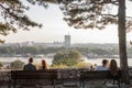 Two couples of lovers sitting on benches observing New Belgrade Novi Beograd at sunset, with the Usce tower in front Royalty Free Stock Photo
