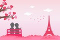 Two couples siting in a chair outdoors with love tree heart shape leaf, pointing at Eiffel tower. Couple lovers scenery in Paris.