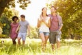 Two couples walking together in the countryside