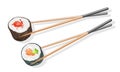 Two couples of wooden chopsticks holding tekkamaki and futomaki sushi rolls. Royalty Free Stock Photo