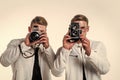 two cousin with retro photo camera. young confident brothers. confident model photographer