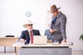 Two male cowboy employees in funny concept Royalty Free Stock Photo