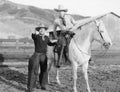 Two cowboys and a white horse Royalty Free Stock Photo