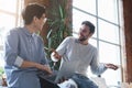 Two coworkers having conversation during break time in office Royalty Free Stock Photo