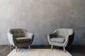 Two cozy grey armchairs standing on white carpet