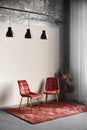 Two cozy red chairs stand on a red carpet in an empty room.Vertical frame Royalty Free Stock Photo